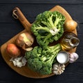 Raw ingredients for cooking cream broccoli soup on wooden background