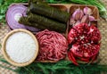 Raw ingredients for cooking dolma. Grape leaves, beef and pomegranate.