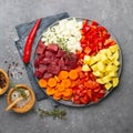 Raw ingredients for cooking goulash or stew - meat, vegetables and spices.