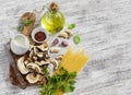 Raw ingredients for cooking pasta with porcini mushrooms - dried porcini mushrooms, spaghetti, cream, garlic, parsley, basil, oliv Royalty Free Stock Photo