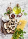 Raw ingredients for cooking pasta with porcini mushrooms - dried porcini mushrooms, spaghetti, cream, garlic, parsley, basil, oliv Royalty Free Stock Photo