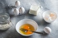 Raw ingredients for making an omelet. Eggs and flour on a gray background. Cooking concept