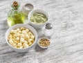 Raw ingredients for making a vegetarian pasta - orecchiette pasta, broccoli and pine nuts pesto sauce, olive oil