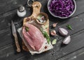 Raw ingredients - meat, red cabbage, onion, garlic, spices and herbs for cooking delicious and healthy lunch. Royalty Free Stock Photo