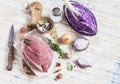 Raw ingredients - meat, red cabbage, onion, garlic, spices and herbs. Cooking delicious and healthy lunch.