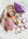 Raw ingredients - meat, red cabbage, onion, garlic, spices and herbs. Cooking delicious and healthy lunch.