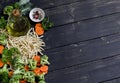 Raw ingredients - pasta, broccoli, carrots, olive oil - cooking delicious vegetarian pasta with vegetables