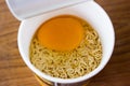 raw instant noodle in cup add egg Royalty Free Stock Photo