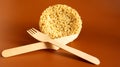 Raw instant noodles in the shape of a circle with a wooden disposable fork. pasta, for the preparation of which it is enough to