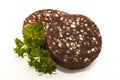 Raw irish black pudding with oatmeal on bright with parsley