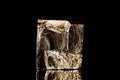 Raw iron pyrite cubical mineral stone in front of black background