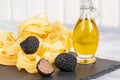 Raw italian fettuccine pasta with black truffles and olive oil Royalty Free Stock Photo