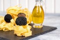 Raw italian fettuccine pasta with black truffles and olive oil Royalty Free Stock Photo