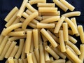 Raw Italian Maccheroni. Italian traditional pasta on dark background. Close-up