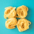 Raw italian pasta fettuccine nest. Spaghetti Tagliatelle nests top view