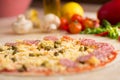 Raw italian salami pizza on table Royalty Free Stock Photo