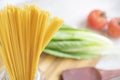 Raw Italian spaghetti and ingredients for cooking. Royalty Free Stock Photo