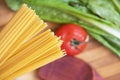 Raw Italian spaghetti and ingredients for cooking. Royalty Free Stock Photo