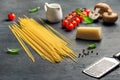 Raw Italian spaghetti with set of ingredients for cooking pasta Royalty Free Stock Photo