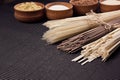 Raw japanese noodles with ingredient in wooden bowls on black striped mat background with copy space. Royalty Free Stock Photo