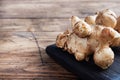 Raw Jerusalem artichoke, topinambur tubers on a rustic wooden background. Copy space Royalty Free Stock Photo