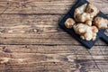 Raw Jerusalem artichoke, topinambur tubers on a rustic wooden background. Copy space Royalty Free Stock Photo