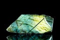 Raw labradorite mineral stone in front of black background Royalty Free Stock Photo