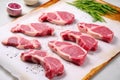 raw lamb chops with grill marks ready to be seasoned on a pink marble slab Royalty Free Stock Photo
