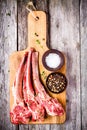 Raw lamb cutlets with salt and pepper