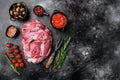 Raw lamb fillet Fresh organic meat, with ingredients and herbs, on black dark stone table background, top view flat lay, with copy Royalty Free Stock Photo