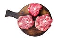 Raw lamb neck chops, fresh mutton meat on a butcher board with herbs. Isolated, white background.