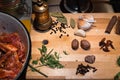 Raw Lamb ribs, herbs and spices on wooden cutting board, vintage spice grinder. Royalty Free Stock Photo