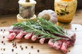 Raw lamb ribs with rosemary, pepper, garlic and oil on wooden board Royalty Free Stock Photo