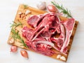 Raw lamb ribs on wooden chopping Board on white background, top Royalty Free Stock Photo