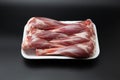 Raw lamb shanks in a white styrofoam box isolated on black background with copy space for text Royalty Free Stock Photo