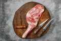 Raw lamb shoulder chump on butcher\'s cutting log