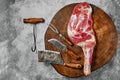 Raw lamb shoulder on butcher`s cutting log with tools Royalty Free Stock Photo
