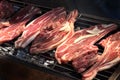 raw lamb steaks on a big grill barbecue Royalty Free Stock Photo