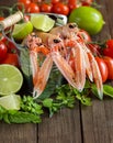 Raw langoustine in a bucket with vegetables and herbs Royalty Free Stock Photo