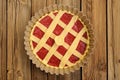 Raw lattice round cake with strawberry jam in metal form on wood Royalty Free Stock Photo