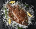 Raw lemon sole fish on ice with herbs and lemon wedges Royalty Free Stock Photo