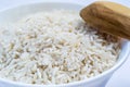 Raw long rice in white plate and wooden spoon Royalty Free Stock Photo