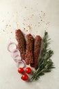Raw lula kebab, herbs and spices on white textured background Royalty Free Stock Photo