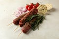 Raw lula kebab, herbs and spices on white textured background Royalty Free Stock Photo