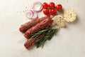 Raw lula kebab, herbs and spices on white textured background Royalty Free Stock Photo