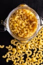 Raw macaroni pasta in glass bottle. Uncooked rigatoni in jar Royalty Free Stock Photo