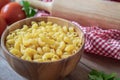 Raw macaroni pasta in wooden bowl Royalty Free Stock Photo