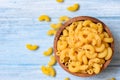 Raw macaroni uncooked delicious pasta or penne noodles / macaroni on wooden bowl background Royalty Free Stock Photo