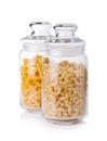 Raw macaronies in a glass jar on a white background Royalty Free Stock Photo