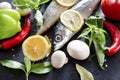 Raw mackerel fish with lemon , chili, pepper, tomato, Basil, onion, mushrooms and spices